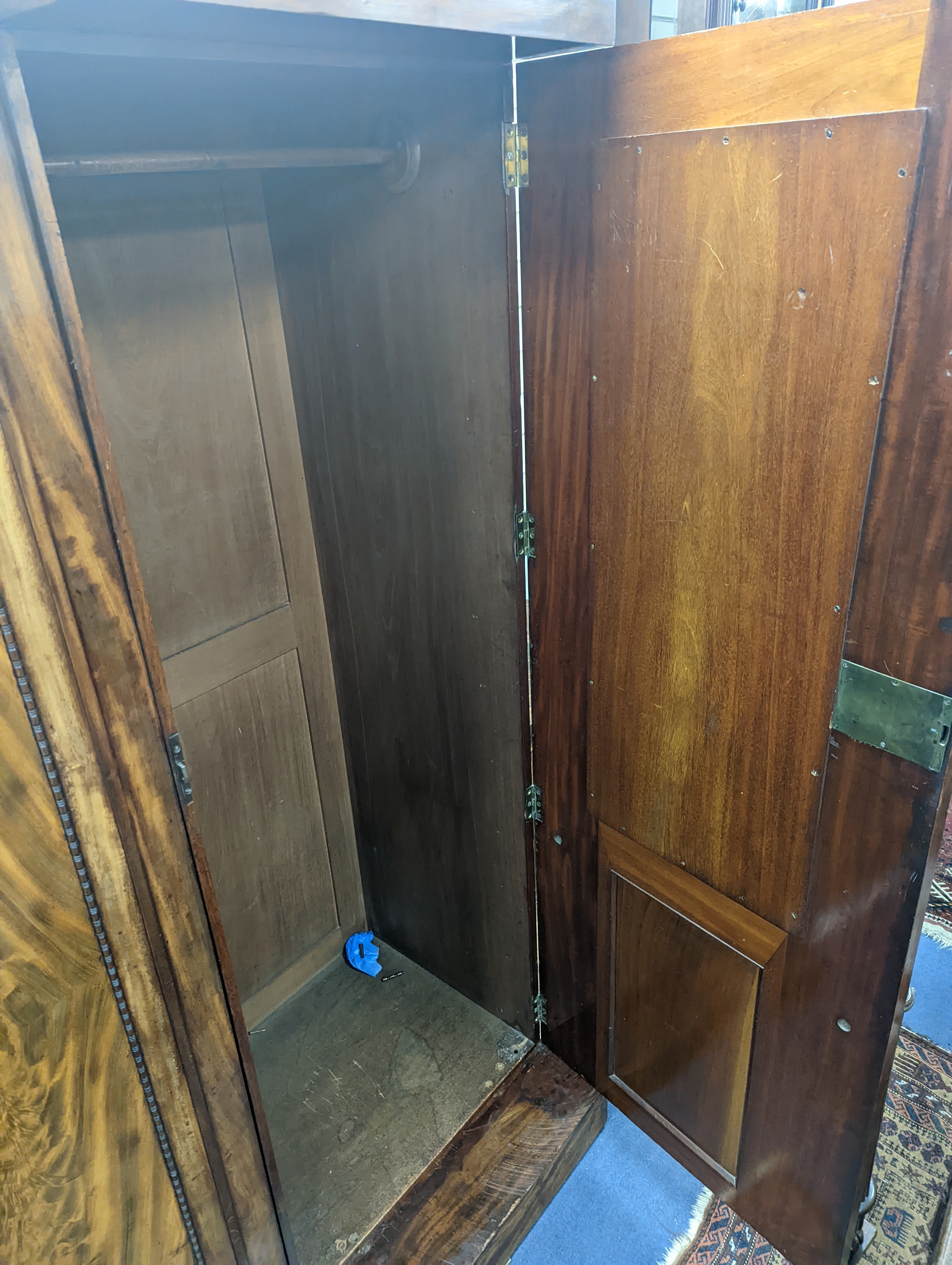 A William IV figured mahogany inverse breakfront compactum wardrobe, length 263cm, depth 70cm, height 197cm